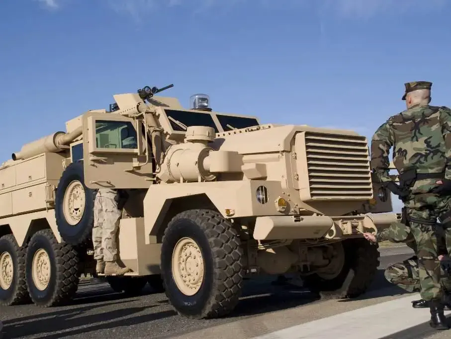 A military vehicle is parked on the side of the road.