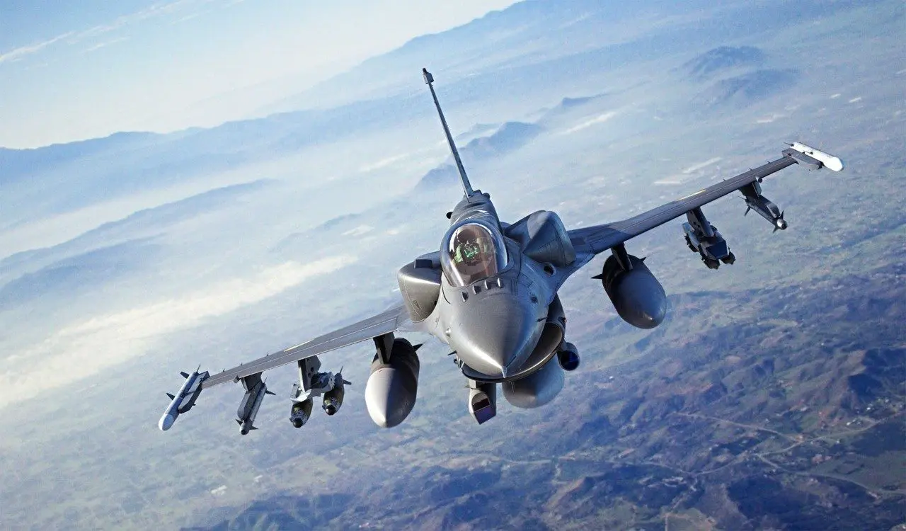 A fighter jet flying through the air with four jets in front of it.